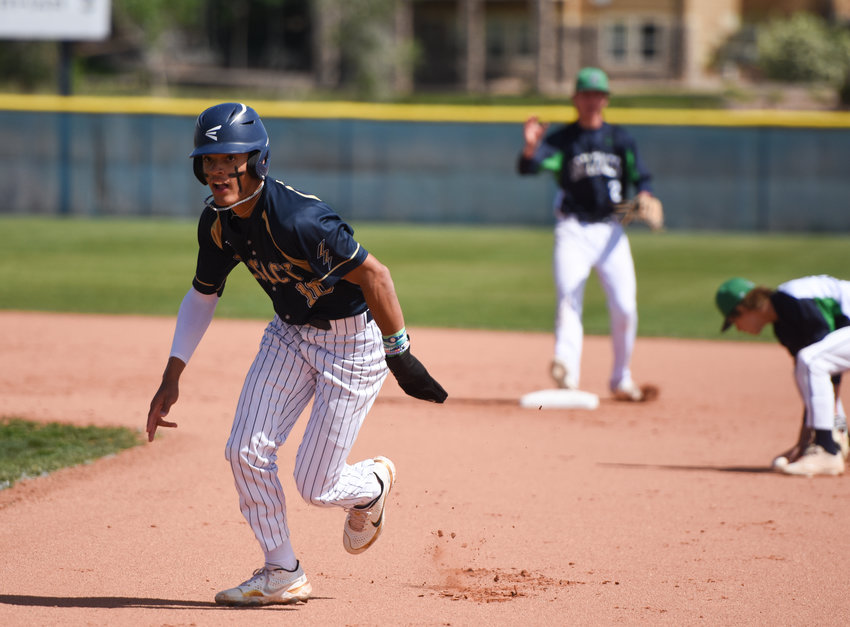 Legacy's Marcus Romero, left, retreats back to first following a ThunderRidge error by second baseman Tyler Davis, right, during a CHSAA 5A regional playoff game at Legacy High School in Broomfield May 23. The Lightning advanced to the state tournament by beating the Grizzlies 8-0 and shading Grandview 5-4.